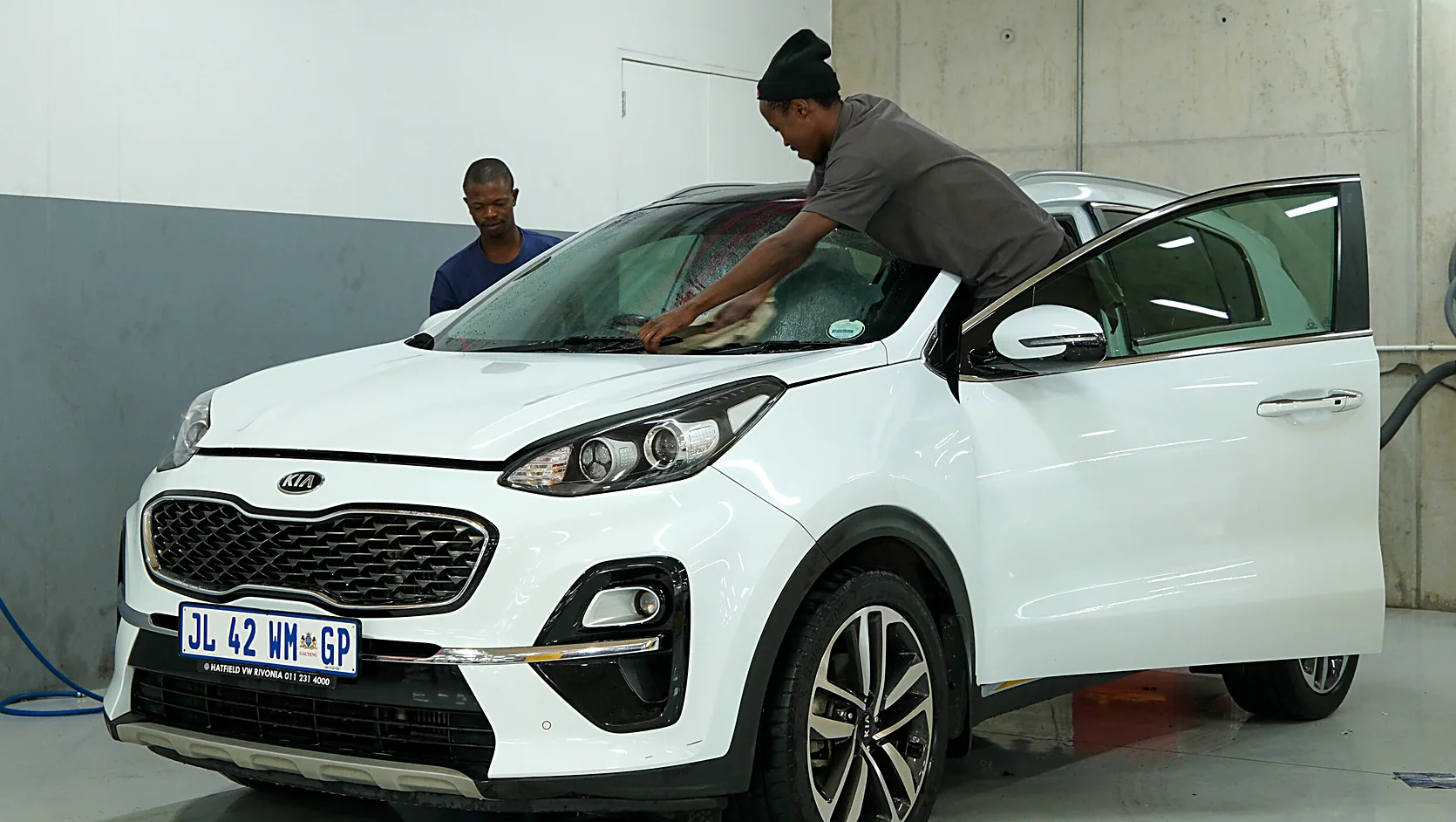 Technician washing and preparing a vehicle before final collection at Renew-it